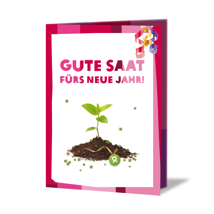 Geschenkkarte mit Aufschrift: Gute Saat fürs neue Jahr! Darunter ein Setzling in Erde, umgeben von Kleeblättern