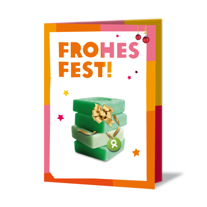 Weihnachtskarte mit Aufschrift: Frohes Fest! Darunter Stapel grüner Seife mit Geschenkband und weihnachtliche Motive